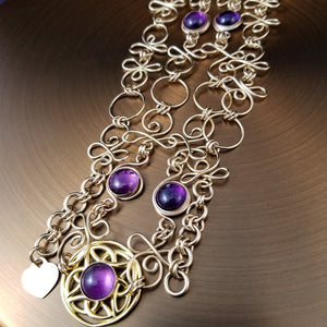 THE CELTIC PRIESTESS LOCKING BELT features chain links inspired by Celtic knots, all created entirely by hand using only a few hand tools. The links are then tumbled with steel shot, creating strength and durability, as well as a silky smoothness. Amethyst and Gold Filled. By My Secret Heart Studios