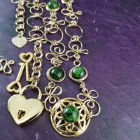 THE CELTIC PRIESTESS LOCKING BELT features chain links inspired by Celtic knots, all created entirely by hand using only a few hand tools. The links are then tumbled with steel shot, creating strength and durability, as well as a silky smoothness. Chrome Diopside and Gold Filled Links. By My Secret Heart Studios