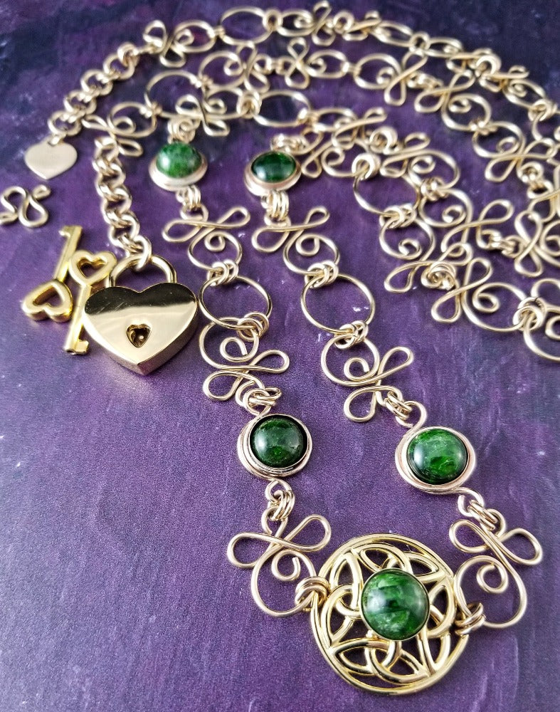 THE CELTIC PRIESTESS LOCKING BELT features chain links inspired by Celtic knots, all created entirely by hand using only a few hand tools. The links are then tumbled with steel shot, creating strength and durability, as well as a silky smoothness. Chrome Diopside and Gold Filled Links. By My Secret Heart Studios