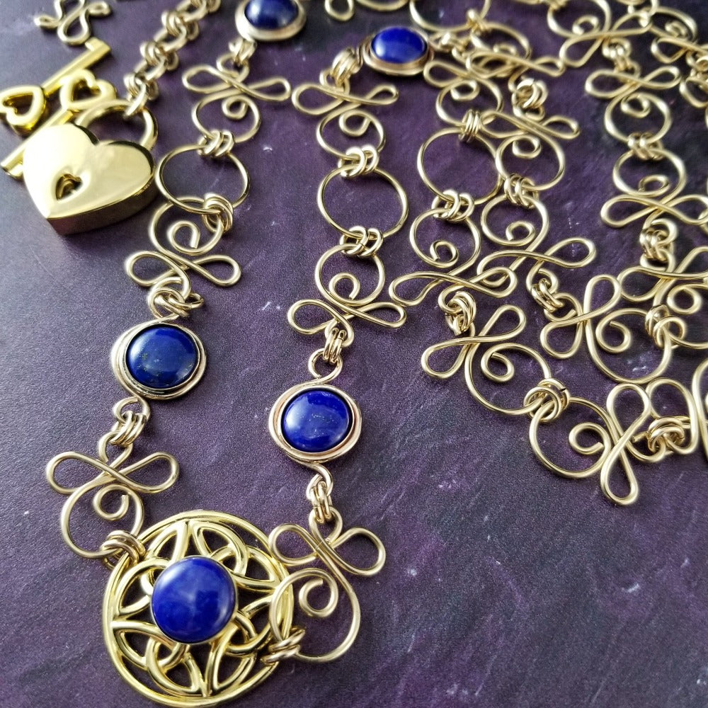 THE CELTIC PRIESTESS LOCKING BELT features chain links inspired by Celtic knots, all created entirely by hand using only a few hand tools. The links are then tumbled with steel shot, creating strength and durability, as well as a silky smoothness. Lapis Lazuli and Gold Filled. By My Secret Heart Studios