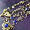 THE CELTIC PRIESTESS LOCKING BELT features chain links inspired by Celtic knots, all created entirely by hand using only a few hand tools. The links are then tumbled with steel shot, creating strength and durability, as well as a silky smoothness. Lapis Lazuli and Gold Filled. By My Secret Heart Studios