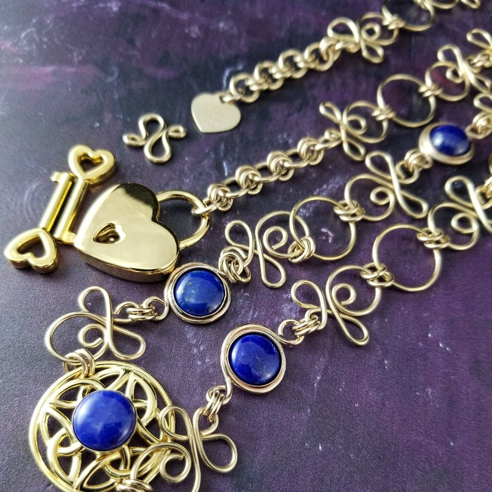 THE CELTIC PRIESTESS LOCKING BELT features chain links inspired by Celtic knots, all created entirely by hand using only a few hand tools. The links are then tumbled with steel shot, creating strength and durability, as well as a silky smoothness. Lapis Lazuli and Gold Filled. By My Secret Heart Studios
