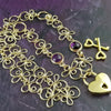 Made a bold statement of your Dominant / submissive lifestyle. The CELTIC PRIESTESS locking submissive collar features chain links inspired by Celtic knots, all created entirely by hand. Embellished with 2 natural gemstone cabochons of your choice.