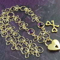 Made a bold statement of your Dominant / submissive lifestyle. The CELTIC PRIESTESS locking submissive collar features chain links inspired by Celtic knots, all created entirely by hand. Embellished with 2 natural gemstone cabochons of your choice.
