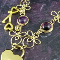 Made a bold statement of your Dominant / submissive lifestyle. The CELTIC PRIESTESS locking submissive collar features chain links inspired by Celtic knots, all created entirely by hand. Embellished with 2 natural gemstone cabochons of your choice.