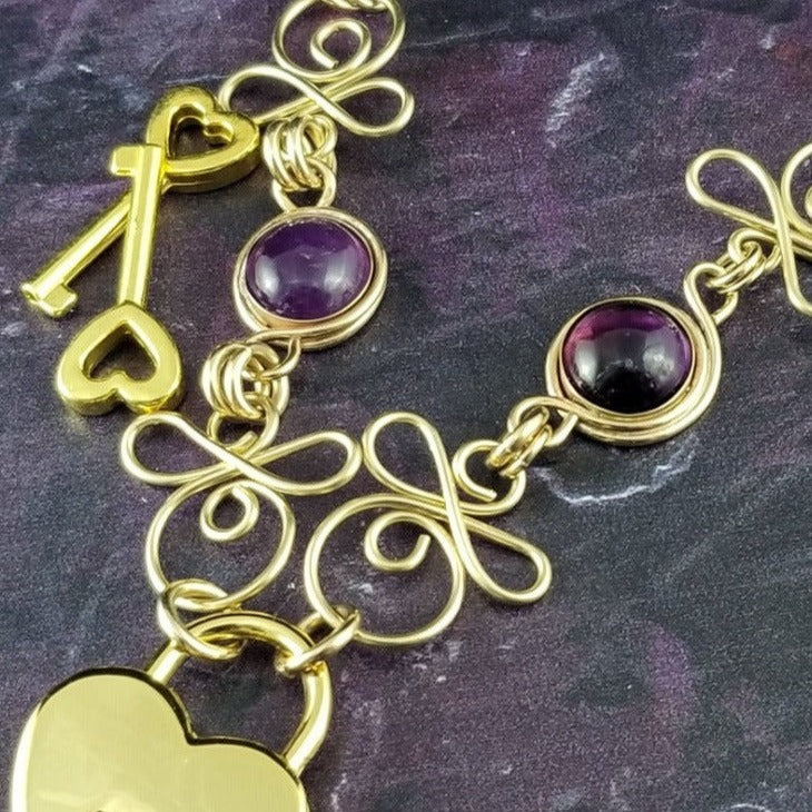 Made a bold statement of your Dominant / submissive lifestyle. The CELTIC PRIESTESS locking submissive collar features chain links inspired by Celtic knots, all created entirely by hand. Embellished with 2 natural gemstone cabochons of your choice.