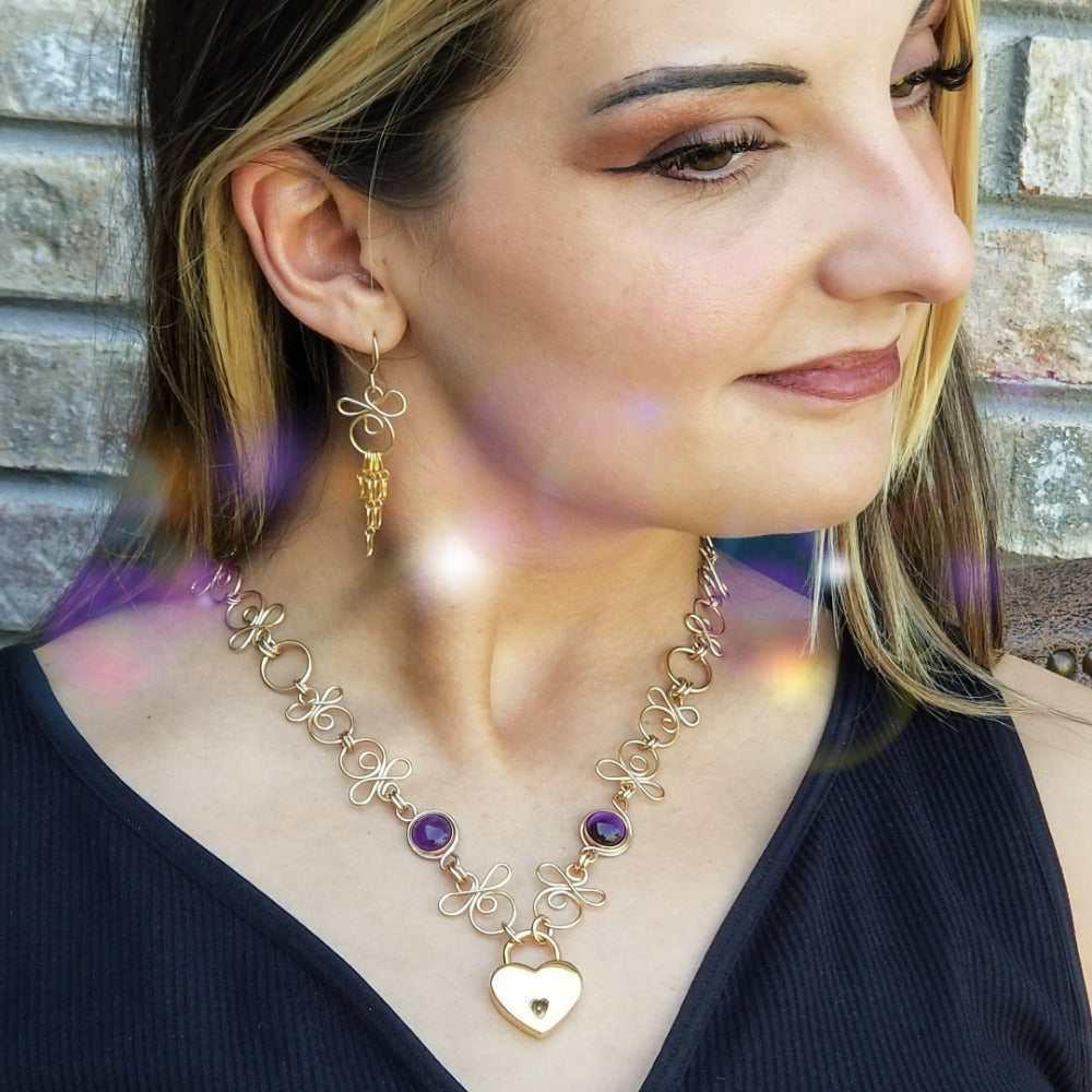 Made a bold statement of your Dominant / submissive lifestyle. The CELTIC PRIESTESS locking submissive collar features chain links inspired by Celtic knots, all created entirely by hand. Embellished with 2 natural gemstone cabochons of your choice.
