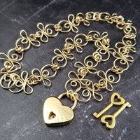 Made a bold statement of your Dominant / submissive lifestyle. The CELTIC PRIESTESS locking submissive collar features chain links inspired by Celtic knots, all created entirely by hand using only a few hand tools. The links are then tumbled with steel shot, creating strength and durability, as well as a silky smoothness. 