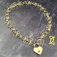 Made a bold statement of your Dominant / submissive lifestyle. The CELTIC PRIESTESS locking submissive collar features chain links inspired by Celtic knots, all created entirely by hand using only a few hand tools. The links are then tumbled with steel shot, creating strength and durability, as well as a silky smoothness. 