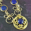 Features chain links inspired by Celtic knots, all created entirely by hand using only a few hand tools. The links are then tumbled with steel shot, creating strength and durability, as well as a silky smoothness.   The center medallion is a gold plated Celtic Triquetra Knot set with natural Lapis Lazuli. My Secret Heart Studios.