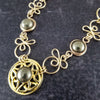 The Celtic Priestess Triquetra Medallion Collar features chain links inspired by Celtic knots, all created entirely by hand using only a few hand tools. The links are then tumbled with steel shot, creating strength and durability, as well as a silky smoothness.   The center medallion is a gold plated Celtic Triquetra Knot set with natural Pyrite. My Secret Heart Studios