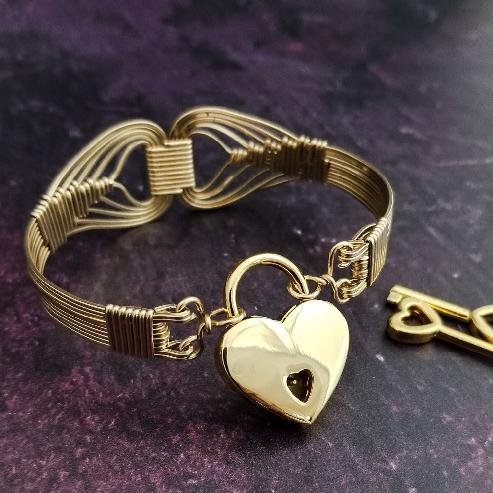 Wire wrapped 14k Gold Filled bracelet inspired by the Egyptian Queen Cleopatra. This locking submissive bracelet is bold and contemporary, and totally discreet for day wear. ORDER A PAIR for stunning handcuffs bracelets or one for sub and one for Dominant. {maybe even chained together!}
