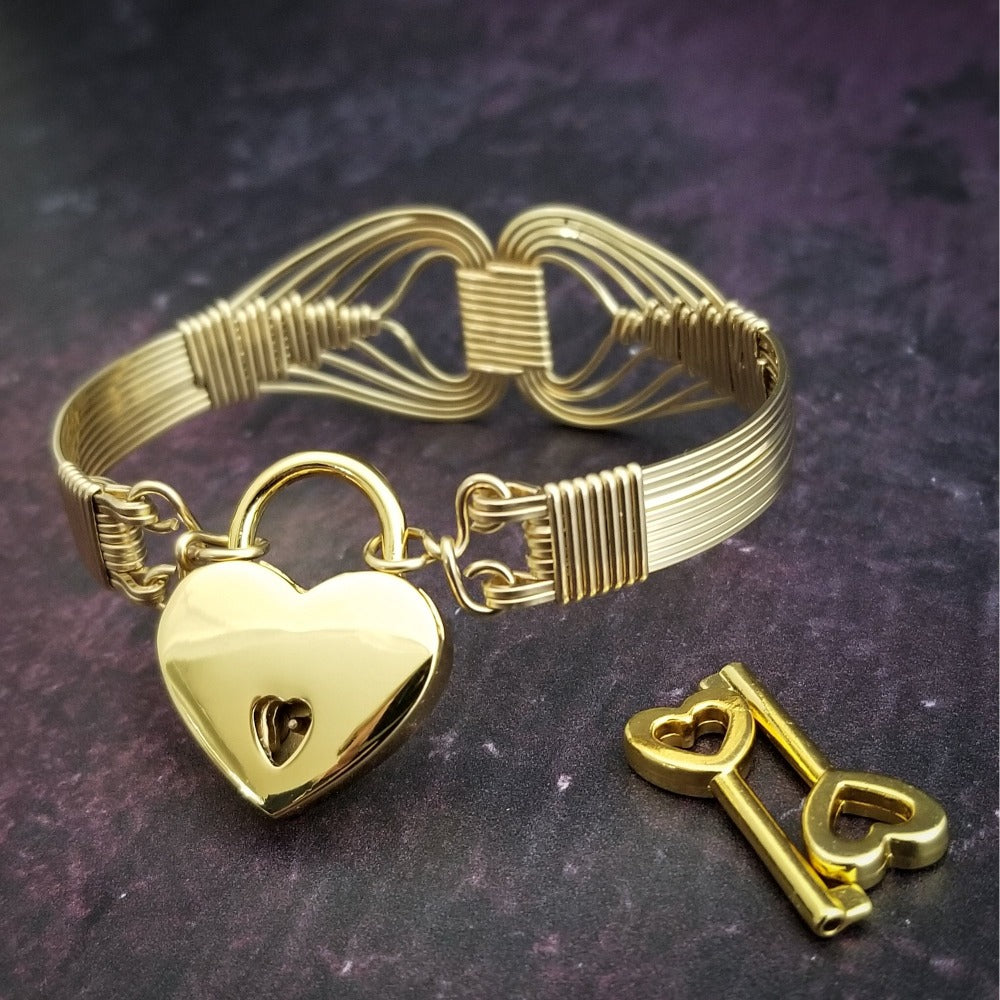 Wire wrapped 14k Gold Filled bracelet inspired by the Egyptian Queen Cleopatra. This locking submissive bracelet is bold and contemporary, and totally discreet for day wear. ORDER A PAIR for stunning handcuffs bracelets or one for sub and one for Dominant. {maybe even chained together!}