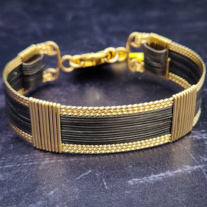 The AMARI BOLD Locking Submissive Bracelet or Anklet, crafted from blackened sterling silver and gold-filled wire, provides a sophisticated, exclusive accent for those who embrace the power of submission. A limited release for the boldest of BDSM boudoirs.