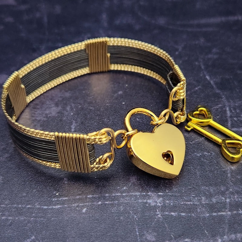The AMARI BOLD Locking Submissive Bracelet or Anklet, crafted from blackened sterling silver and gold-filled wire, provides a sophisticated, exclusive accent for those who embrace the power of submission. A limited release for the boldest of BDSM boudoirs. Limited Release