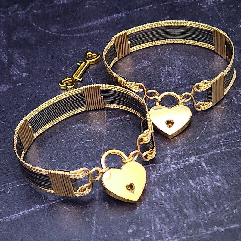 The AMARI BOLD Locking Submissive Bracelet or Anklet, crafted from blackened sterling silver and gold-filled wire, provides a sophisticated, exclusive accent for those who embrace the power of submission. A limited release for the boldest of BDSM boudoirs.