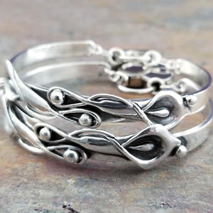 The Calla Lily Handcuff bracelets are a graceful addition to our artisan BDSM jewelry collection. Your submissive is sure to love this feminine and elegant locking cuff. Made in solid sterling silver, with a few links of chain to create a comfortable, 'movable' fit, even when locked. Total discretion!