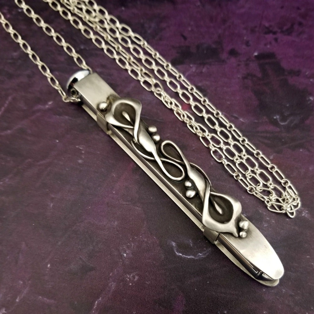 A necklace with a kinky secret! This sexy sterling silver pendant cages a sleek, sexy vibrator. The garden inspired necklace is from one of our best selling designs, The Calla Lily Collection.