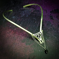 Inspired by campfires, music and moonlight dancing. Ancient past, present and future. Substantial open back style collar has a nice fluid curve that hugs the neck. Celtic knot with swag chain and black onyx bead. Created in all luxurious sterling silver, its solid, weighty construction makes it a timeless piece that you'll be able to enjoy for years to come. My Secret Heart Studios