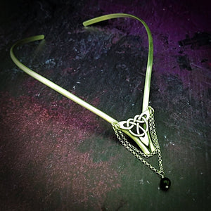Inspired by campfires, music and moonlight dancing. Ancient past, present and future. Substantial open back style collar has a nice fluid curve that hugs the neck. Celtic knot with swag chain and black onyx bead. Created in all luxurious sterling silver, its solid, weighty construction makes it a timeless piece that you'll be able to enjoy for years to come. My Secret Heart Studios