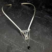 Inspired by campfires, music and moonlight dancing. Ancient past, present and future. Substantial open back style collar has a nice fluid curve that hugs the neck. Celtic knot with swag chain and black onyx bead. Created in all luxurious sterling silver, its solid, weighty construction makes it a timeless piece that you'll be able to enjoy for years to come. My Secret Heart Studios