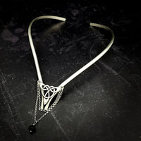 Inspired by campfires, music and moonlight dancing. Ancient past, present and future. Substantial open back style collar has a nice fluid curve that hugs the neck. Celtic knot with swag chain and black onyx bead. Created in all luxurious sterling silver, its solid, weighty construction makes it a timeless piece that you'll be able to enjoy for years to come. My Secret Heart Studios