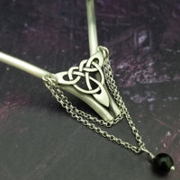 Inspired by campfires, music and moonlight dancing. Ancient past, present and future. Substantial open back style collar has a nice fluid curve that hugs the neck. Celtic knot with swag chain and black onyx bead. Created in all luxurious sterling silver, its solid, weighty construction makes it a timeless piece that you'll be able to enjoy for years to come. My Secret Heart Studios