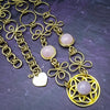 THE CELTIC PRIESTESS MEDALLION BELT features chain links inspired by Celtic knots, all created entirely by hand using luxurious 14K Gold Filled wire and hand selected gemstone cabochons.