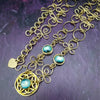 THE CELTIC PRIESTESS MEDALLION BELT features chain links inspired by Celtic knots, all created entirely by hand using luxurious 14K Gold Filled wire and hand selected gemstone cabochons. 