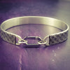 Boldly state your BDSM lifestyle with the Darkenwald cuffs / anklets. Our Darkenwald design is reminiscent of old castle walls, knights on galloping horses and laughter and ale in the great hall by firelight.  Substantial sterling silver cuffs accommodate a traditional clasp for discretion, but can also be worn with a padlock and key for a big statement of Ownership. Nice hefty bracelets for a lifetime of play and pleasure.