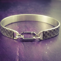 Boldly state your BDSM lifestyle with the Darkenwald cuffs / anklets. Our Darkenwald design is reminiscent of old castle walls, knights on galloping horses and laughter and ale in the great hall by firelight.  Substantial sterling silver cuffs accommodate a traditional clasp for discretion, but can also be worn with a padlock and key for a big statement of Ownership. Nice hefty bracelets for a lifetime of play and pleasure.