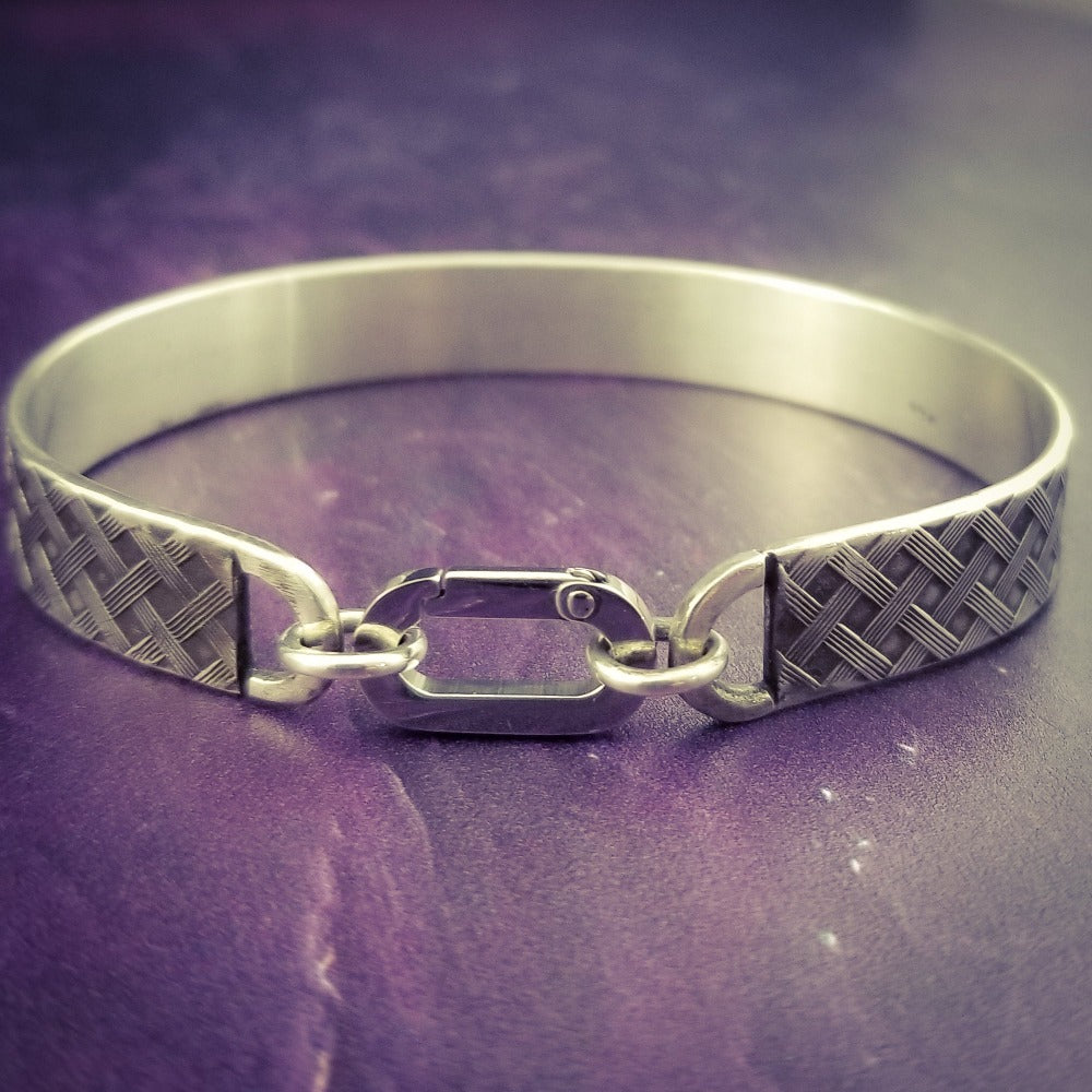 Boldly state your BDSM lifestyle with the Darkenwald cuffs / anklets. Our Darkenwald design is reminiscent of old castle walls, knights on galloping horses and laughter and ale in the great hall by firelight.  Substantial sterling silver cuffs accommodate a traditional clasp for discretion, but can also be worn with a padlock and key for a big statement of Ownership. Nice hefty bracelets for a lifetime of play and pleasure.