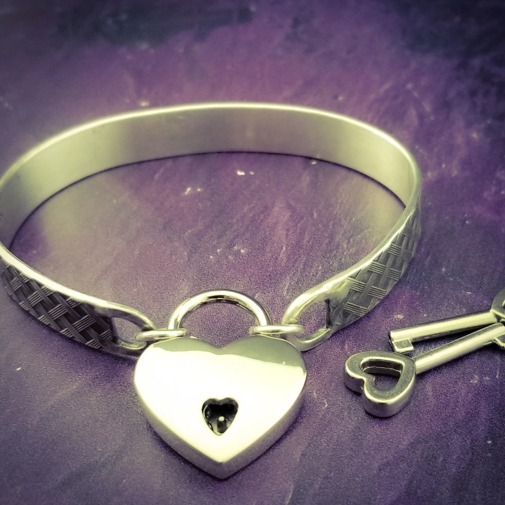 Boldly state your BDSM lifestyle with the Darkenwald cuffs / anklets. Our Darkenwald design is reminiscent of old castle walls, knights on galloping horses and laughter and ale in the great hall by firelight.  Substantial sterling silver cuffs accommodate a traditional clasp for discretion, but can also be worn with a padlock and key for a big statement of Ownership. Nice hefty bracelets for a lifetime of play and pleasure.
