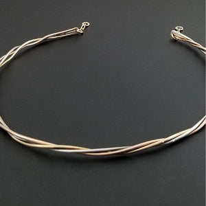Precious metals are gently woven together into a locking submissive collar that is pure luxury. Beautifully discreet for day wear, it certainly looks like a traditional collar, but ... a lock in the back reminds the submissive of their trust and devotion to their Dominant.  Can be worn locked or with a traditional clasp for total discretion.