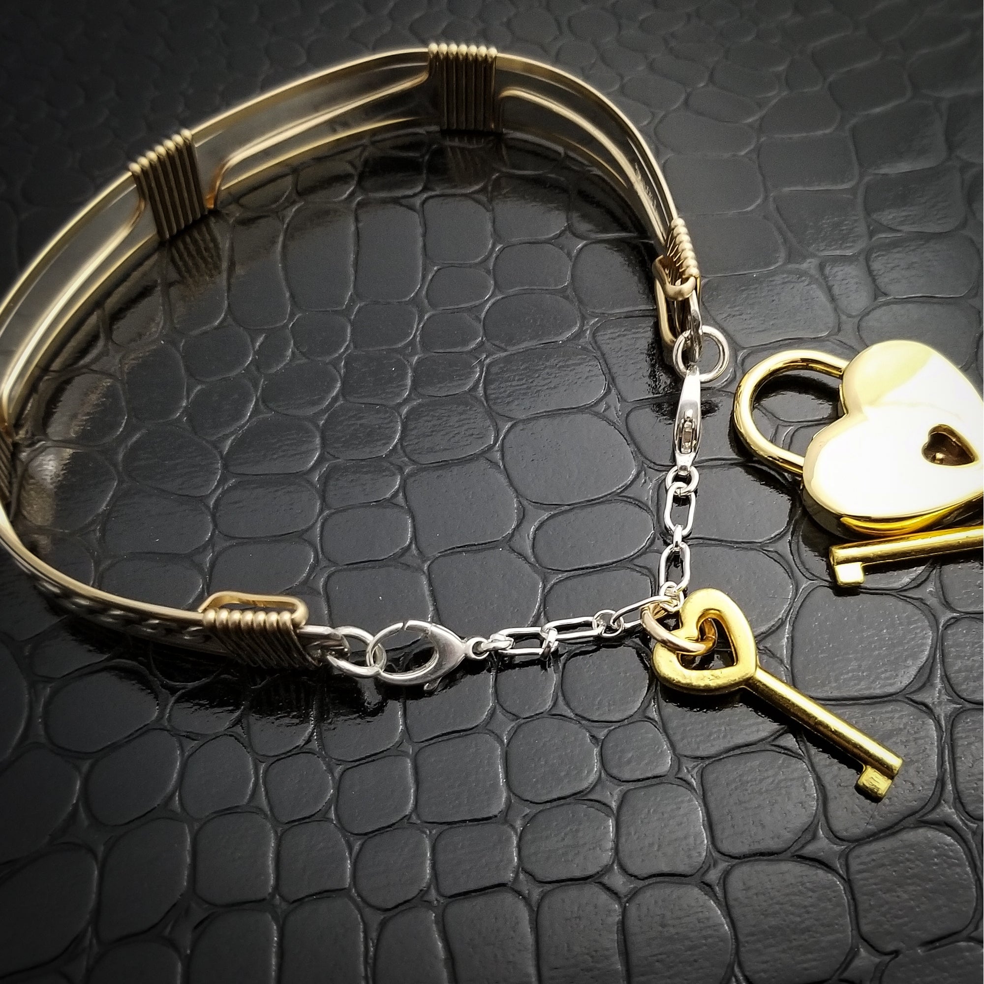 This sterling silver Key Cuff is created with a detachable chain that holds the key to Your slave or sub's locked collars or cuffs. Jewelry clasps clip into rings that attach to the cuff, which makes removing the chain simple. 
