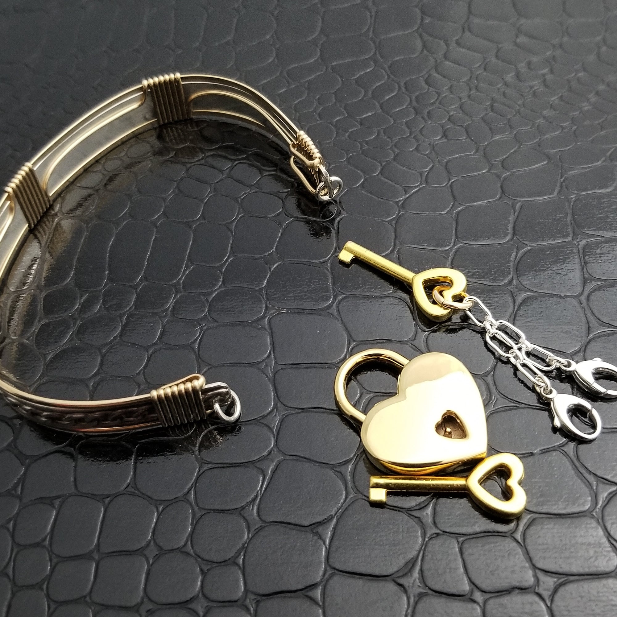 This sterling silver Key Cuff is created with a detachable chain that holds the key to Your slave or sub's locked collars or cuffs. Jewelry clasps clip into rings that attach to the cuff, which makes removing the chain simple. 