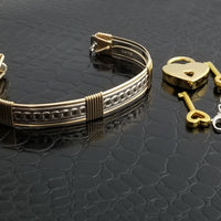 This sterling silver Key Cuff is created with a detachable chain that holds the key to Your slave or sub's locked collars or cuffs. Jewelry clasps clip into rings that attach to the cuff, which makes removing the chain simple. 