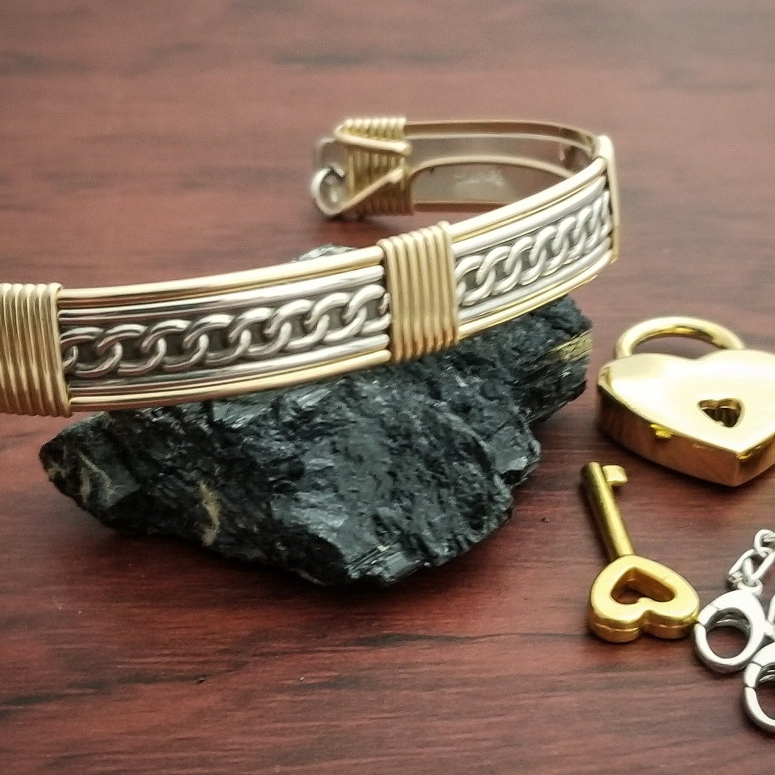 This sterling silver Key Cuff is created with a detachable chain that holds the key to Your slave or sub's locked collars or cuffs. Jewelry clasps clip into rings that attach to the cuff, which makes removing the chain simple. 