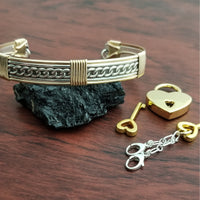 This sterling silver Key Cuff is created with a detachable chain that holds the key to Your slave or sub's locked collars or cuffs. Jewelry clasps clip into rings that attach to the cuff, which makes removing the chain simple. 