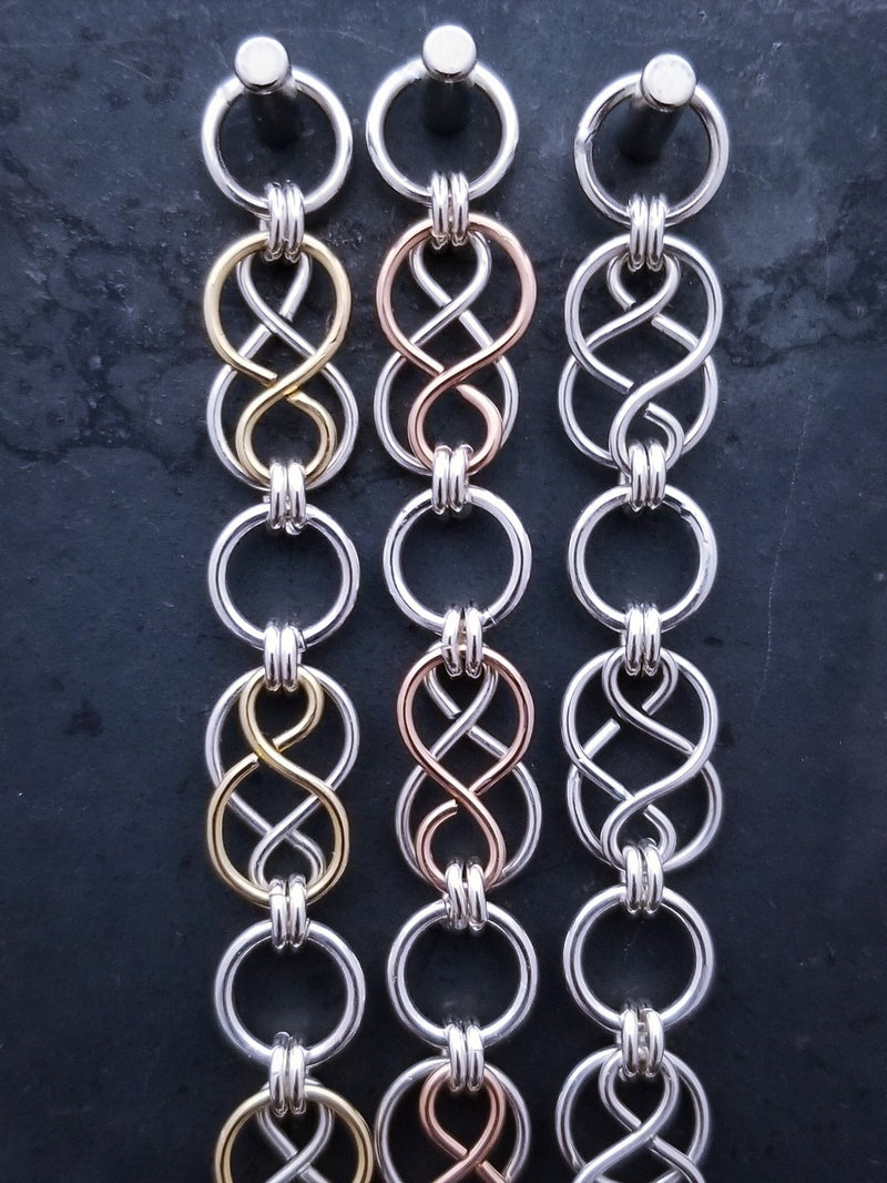 Beautifully entwined lives. Eternal Chains are symbolic of your journey. Featuring chain links inspired by Celtic knots, all created entirely by hand using only a few hand tools. The links are then tumbled with steel shot, creating strength and durability, as well as a silky smoothness. Made a bold statement of your Dominant / submissive or BDSM lifestyle.