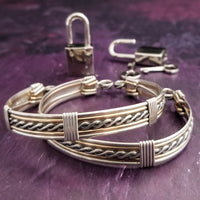 Our Entwined Collection is themed around ropes, paying homage to the ancient art of shibari. These locking BDSM submissive bracelets are so beautifully discreet.  Created in sterling with slim bands of 14k gold filled accents. Can be worn as wrist or ankle restraints.  
