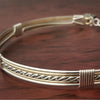 Sterling submissive collar that is discreet for daytime, yet kinky for playtime. The Celtic inspired design features a rope pattern, with accent lines of sterling and 14k gold filled, all wrapped together with sterling wraps. 