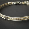 Sterling submissive collar that is discreet for daytime, yet kinky for playtime. The Celtic inspired design features a rope pattern, with accent lines of sterling and 14k gold filled, all wrapped together with sterling wraps. 