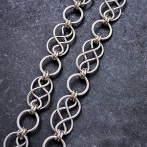 Beautifully entwined lives. Eternal Chains are symbolic of your journey. Featuring chain links inspired by Celtic knots, all created entirely by hand using only a few hand tools. The links are then tumbled with steel shot, creating strength and durability, as well as a silky smoothness. Made a bold statement of your Dominant / submissive or BDSM lifestyle.