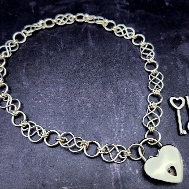 Beautifully entwined lives. Eternal Chains are symbolic of your journey. Featuring chain links inspired by Celtic knots, all created entirely by hand using only a few hand tools. The links are then tumbled with steel shot, creating strength and durability, as well as a silky smoothness. Made a bold statement of your Dominant / submissive or BDSM lifestyle.