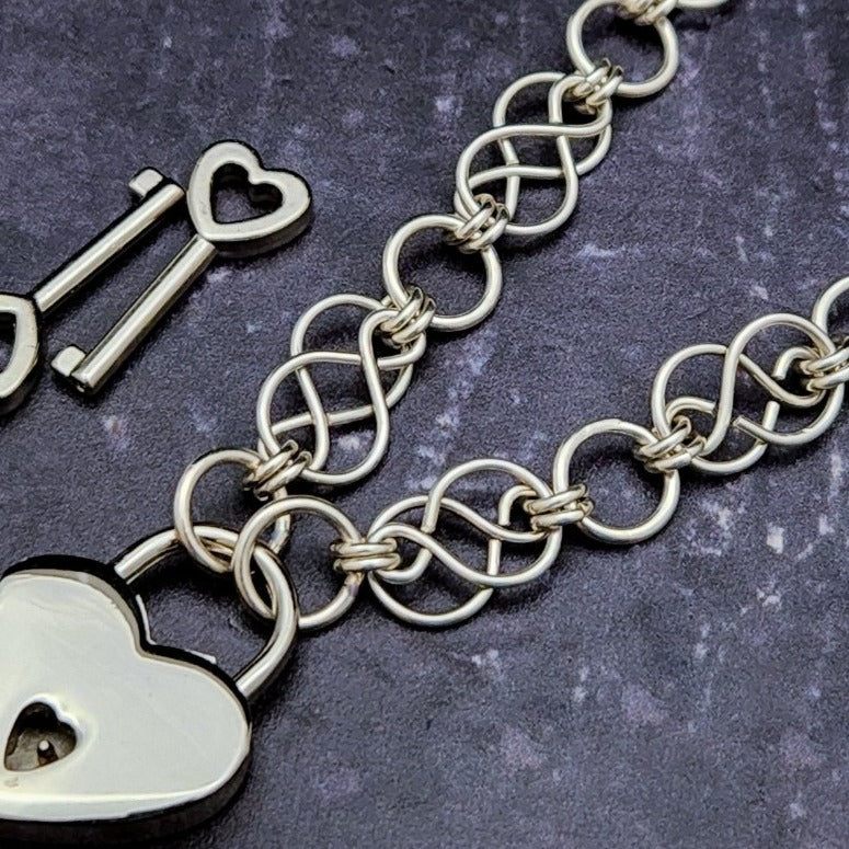 Beautifully entwined lives. Eternal Chains are symbolic of your journey. Featuring chain links inspired by Celtic knots, all created entirely by hand using only a few hand tools. The links are then tumbled with steel shot, creating strength and durability, as well as a silky smoothness. Made a bold statement of your Dominant / submissive or BDSM lifestyle.