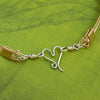 Precious metals embrace to create a seductive collection of artisan wire wrapped jewelry. Big, bold and dramatic, this unisex artisan collar is created with centuries old wire wrapping techniques, using only a few hand tools.