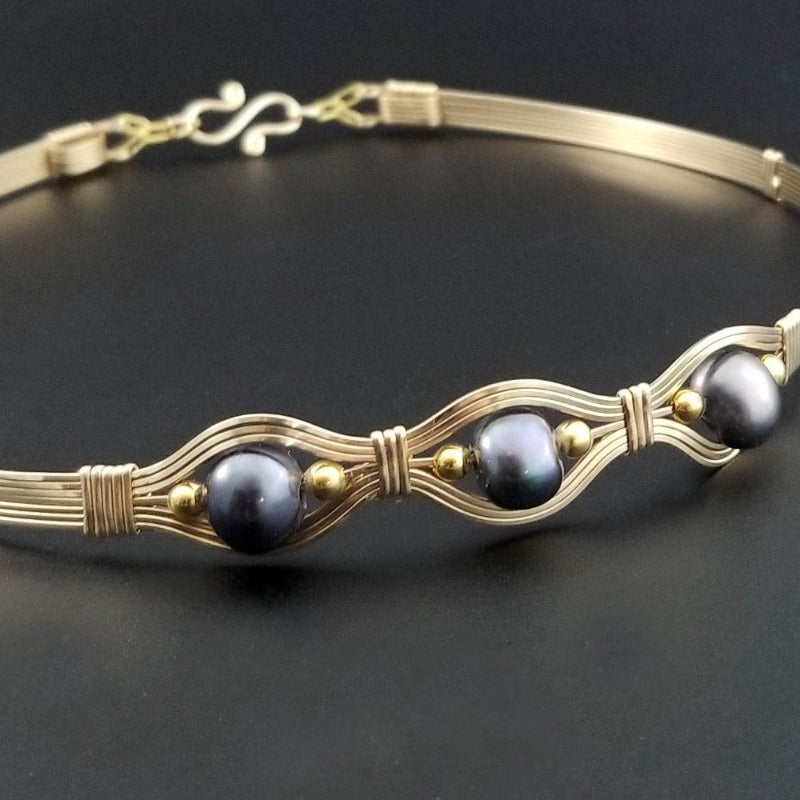 Luxurious gold surrounds large freshwater pearls in an exotic peacock color {blues and greens} in this submissive locking BDSM collar. It's bold, yet delicate and oh so feminine. Show your ownership or submission with beauty and grace.