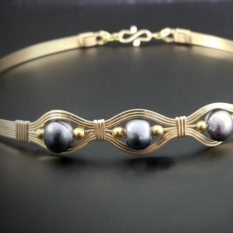 Luxurious gold surrounds large freshwater pearls in an exotic peacock color {blues and greens} in this submissive locking BDSM collar. It's bold, yet delicate and oh so feminine. Show your ownership or submission with beauty and grace.