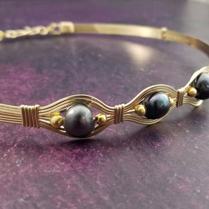 Luxurious gold surrounds large freshwater pearls in an exotic peacock color {blues and greens} in this submissive locking BDSM collar. It's bold, yet delicate and oh so feminine. Show your ownership or submission with beauty and grace.